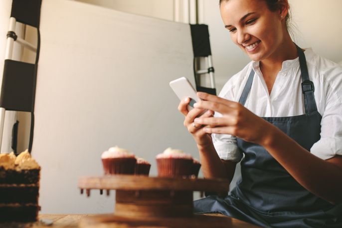 Audrey, a baker, decorating a cake